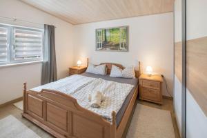 a bedroom with a bed with a dog laying on it at Ferienhaus Bornwiese in Schwalmtal
