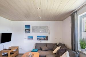 a living room with a couch and a table at Ferienhaus Bornwiese in Schwalmtal