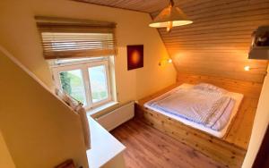 a bedroom with a bed in a room with a window at Ferienwohnung Schmilau in Schmilau