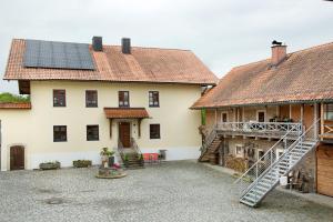 a courtyard of a house with a staircase and roofs at Schönauer Hof - Wohnung Paula in Passau