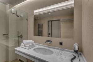 a bathroom with a sink and a mirror at Villa Wierchy in Zakopane