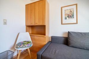 a living room with a couch and a chair at Ferienwohnung 2 Schulze in Neustrelitz