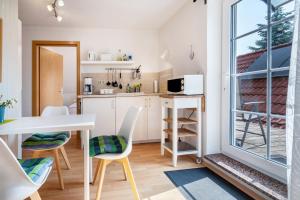 a kitchen with a table and chairs and a window at Ferienwohnung 2 Schulze in Neustrelitz