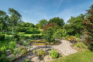 a park bench in the middle of a garden at Ferienwohnung 2 Schulze in Neustrelitz