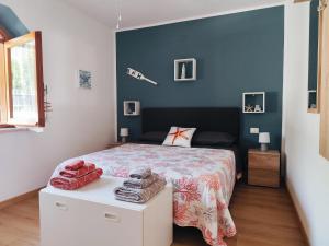 a bedroom with a bed and a blue wall at B&B Relax Gonone in Cala Gonone