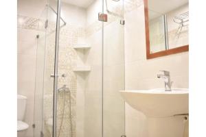 a bathroom with a sink and a shower at Manolika Studio 6 in Kithnos