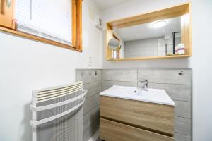 a bathroom with a sink and a mirror at Chalet Du Wason in Xonrupt-Longemer +24 photos