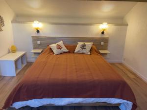 a bedroom with a large bed with two pillows at Maison Gaia in Valdeblore