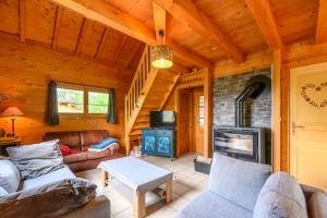 a living room with a couch and a fireplace at Chalet Du Wason in Xonrupt-Longemer