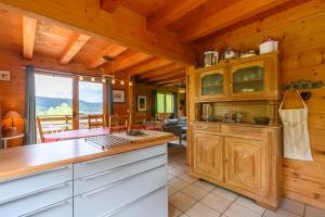 a kitchen with wooden cabinets and a dining room at Chalet Du Wason in Xonrupt-Longemer