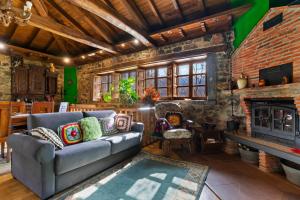a living room with a couch and a fireplace at La Casa De La Torre in Dosango