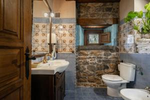 a bathroom with a toilet and a sink at La Casa De La Torre in Dosango +21 photos