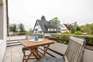 a small wooden table on a balcony with two chairs at Bad day good day in Horn-Bad Meinberg