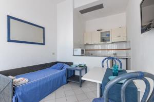 a small hospital room with a bed and a table at Appartamento con vista mare Chiessi in Chiessi