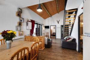 a dining room and living room with a table and chairs at Chalet Pla Del Mir in Les Angles
