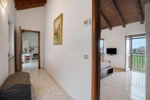 a living room with white walls and a large window at La mansarda di Mariuccia in Castelletto sopra Ticino