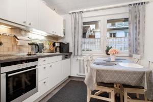 a kitchen with a small table with a table cloth at Ferienwohnungen Michael u Christine in Langenargen