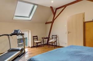 a bedroom with a bed and a table and chairs at Vierseitenhof mit Pool in Ziesar +33 photos