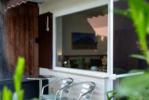 two chairs sitting in front of a window at Apartment Biendl in Mittenwald