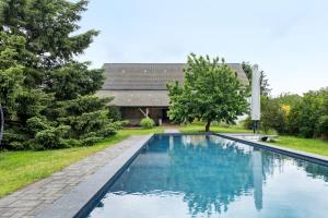 a swimming pool in the yard of a house at Vierseitenhof mit Pool in Ziesar