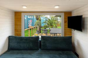 a screened in porch with two chairs and a flat screen tv at Tiny House Nr 6 in Schwielowsee