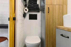 a small bathroom with a toilet and a sink at Tiny House Nr 6 in Schwielowsee +19 photos