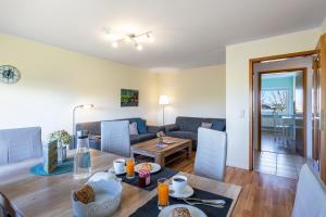 a living room with a table and a couch at Ferienhof Dethlefsen in Pellworm
