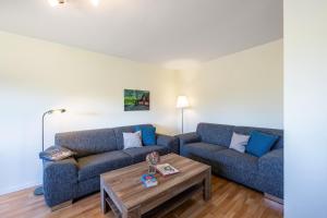 a living room with two couches and a coffee table at Ferienhof Dethlefsen in Pellworm