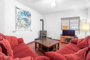 a living room with a red couch and a table at Villa Casablanca Apartment in Torrent