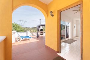 an open door to a patio with a blue chair at Villa Casablanca Apartment in Torrent