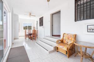 a living room with a chair and a table at Villa Casablanca Apartment in Torrent