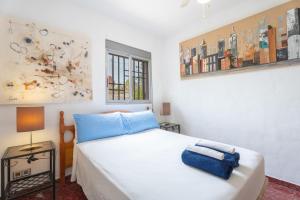 a bedroom with a white bed with blue towels on it at Villa Casablanca Apartment in Torrent +26 photos