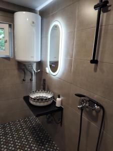 a bathroom with a sink and a mirror at Chergata Guest House in Zheglitsa +78 photos