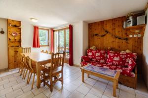 a living room with a table and a couch at Edelweiss in Valloire