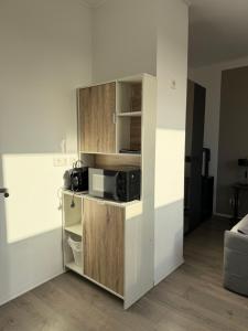 a small kitchen with a microwave in a room at Gästehaus Orchidee in Hoya +11 photos
