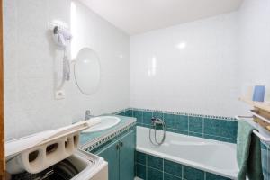 a bathroom with a sink and a washing machine at Edelweiss in Valloire +19 photos