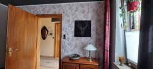 a hallway with a door and a lamp on a table at Fewo Haus Cäcilia in Elsdorf