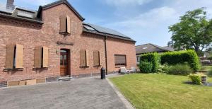 a brick house with a yard in front of it at Fewo Haus Cäcilia in Elsdorf