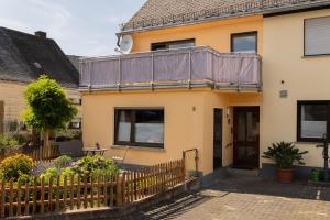 a house with a balcony on top of it at Haus Jakob in Longkamp
