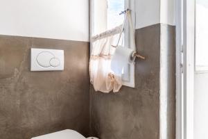 a bathroom with a toilet and a window at Il Pescino in Pietrasanta