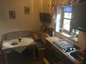 a small living room with a couch and a table at Ferienwohnung Stark in Scheßlitz +11 photos