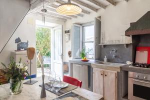 a kitchen with a sink and a table in a room at Il Pescino in Pietrasanta