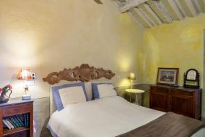 a bedroom with a large bed with a wooden headboard at Il Pescino in Pietrasanta