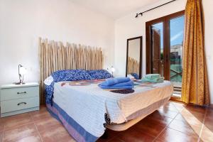 a bedroom with a bed and a large window at Villa Charlotte in La Oliva +16 photos