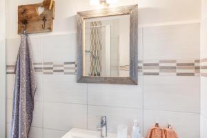a bathroom with a mirror and a sink at Ferienwohnung Kleisl in Grainau +12 photos