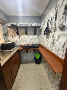 a kitchen with marble walls and a counter top at Max Horizon in Ikeja +16 photos