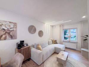 a living room with a couch and a table at Casa Kokorey in Rellingen +6 photos