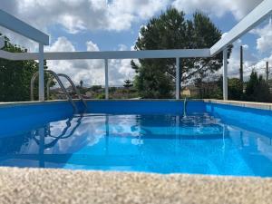 a swimming pool with a blue swimming pool at Cal Jaume in Masquefa