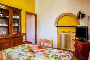 a room with a table and a tv and a kitchen at Le Gerlette - La Capanna in Braccagni