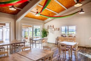 a dining room with tables and chairs and windows at Le Gerlette - La Capanna in Braccagni